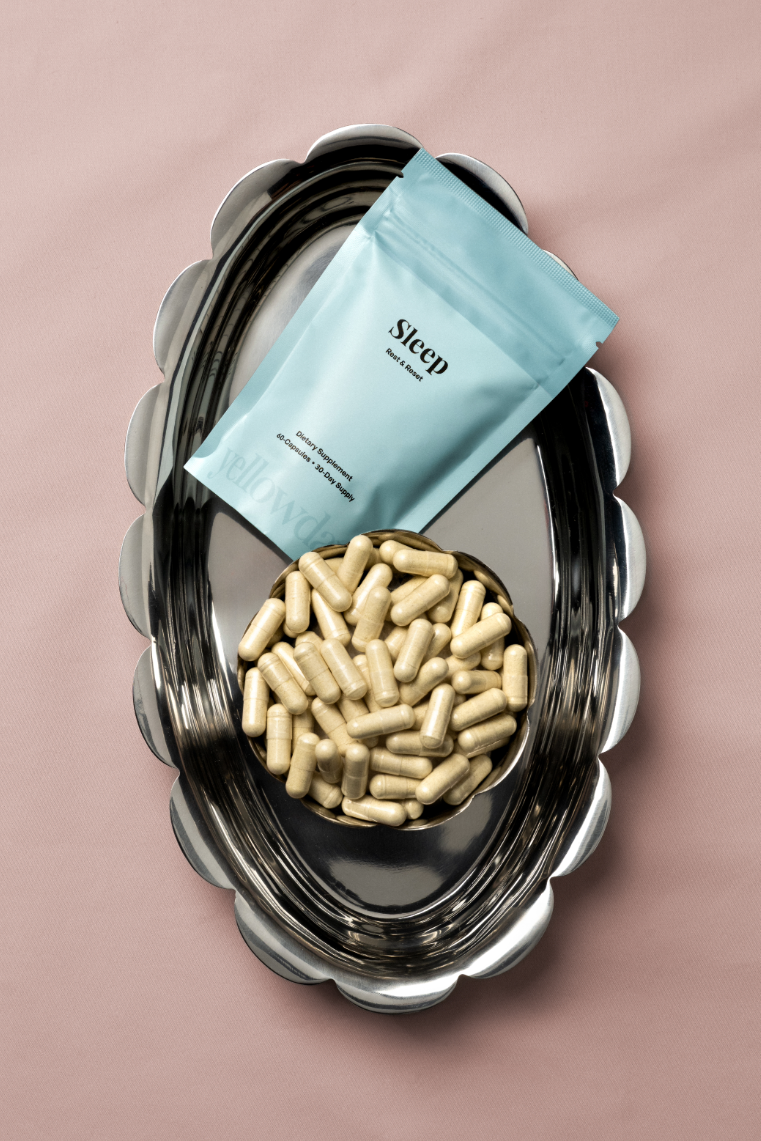 Yellowday Sleep supplement pouch and capsules on a tray